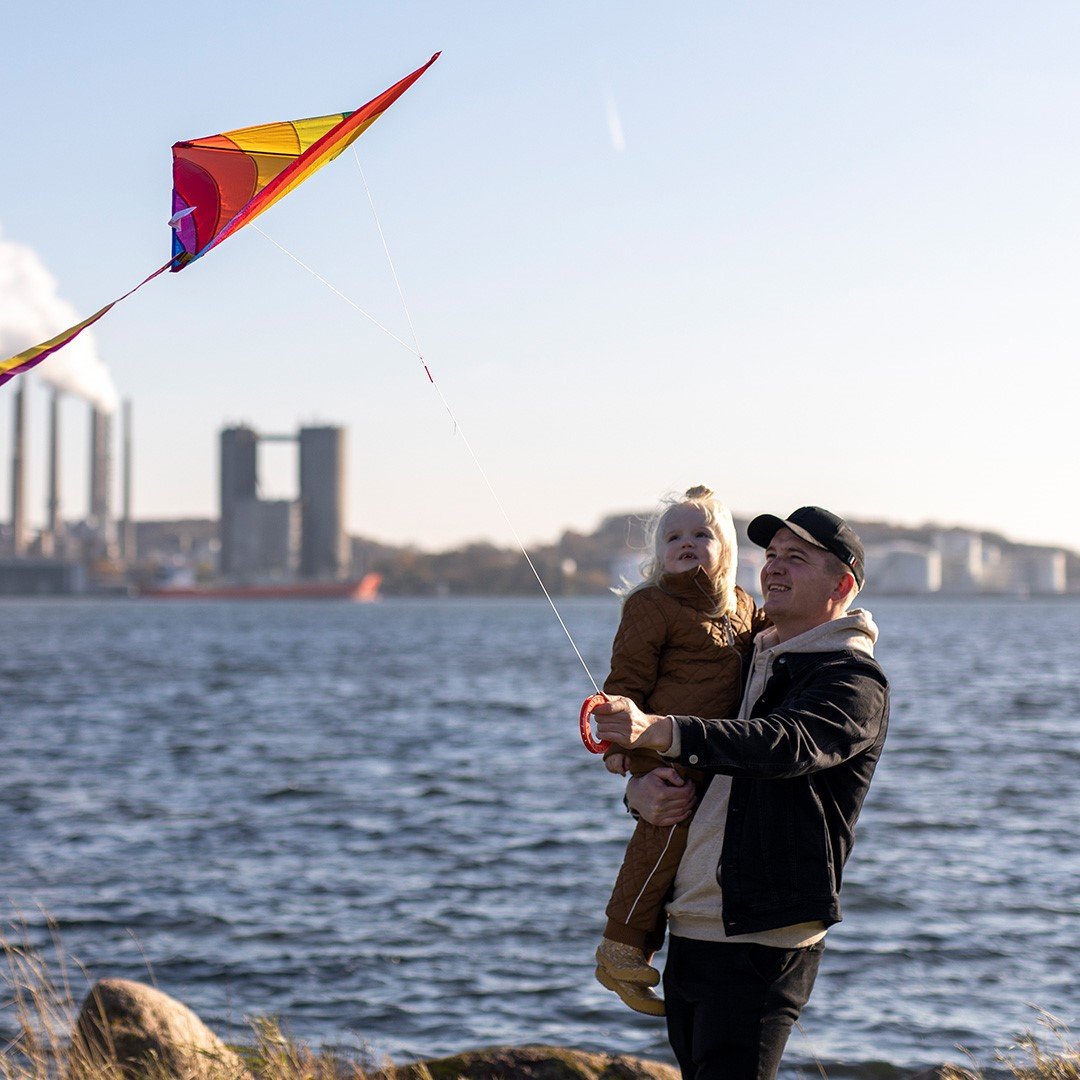 father flying kite with his daughter