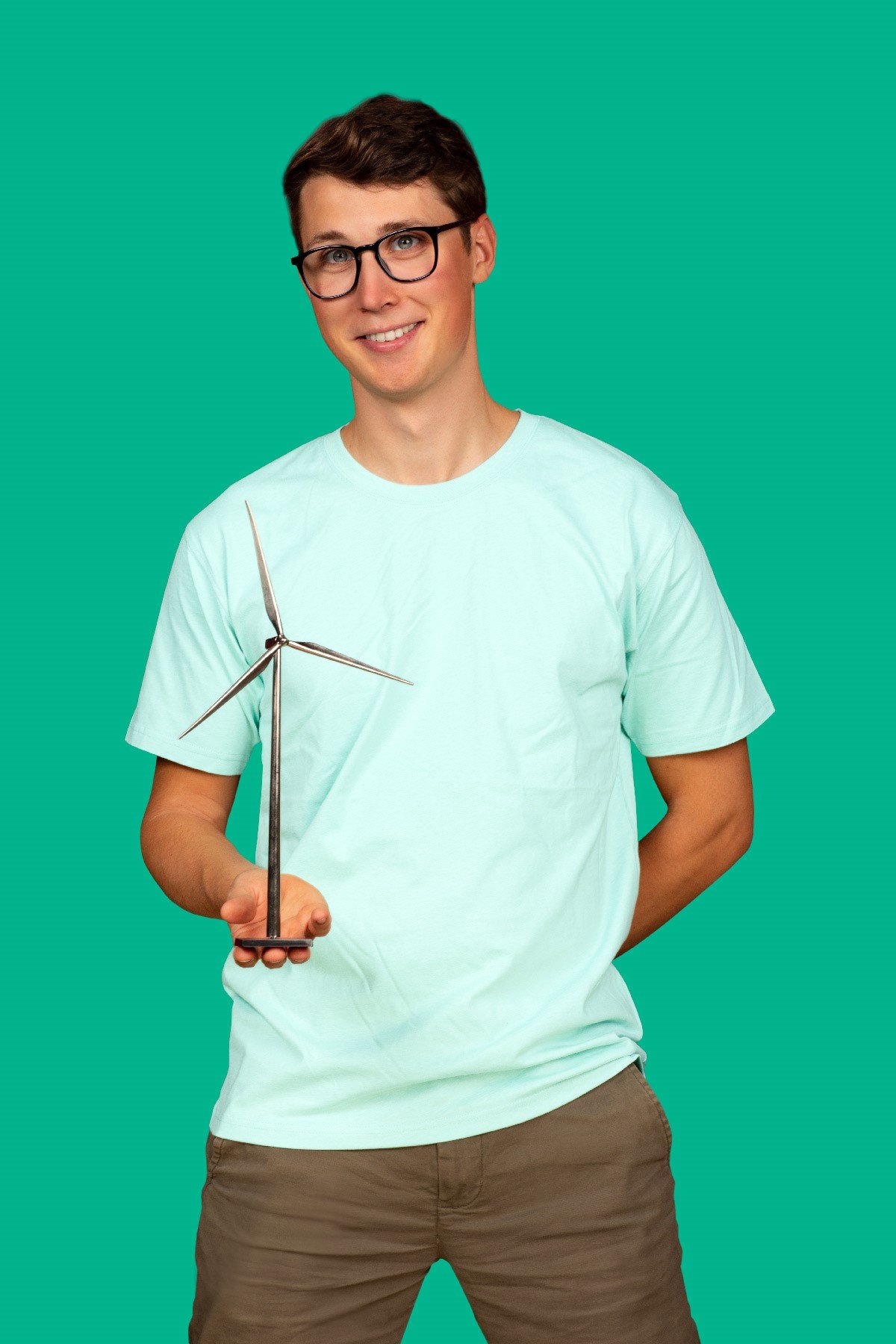 Jens D in green shirt holding a mini wind mill