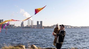 Father and little daughter are flowing a kite in Aalborg Portland