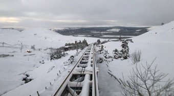 snowy train rails going downhill